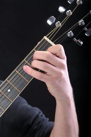 Human hand taking  E-major accord at guitar