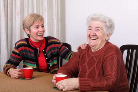 Senior and mature womans drinking caffee and laughing