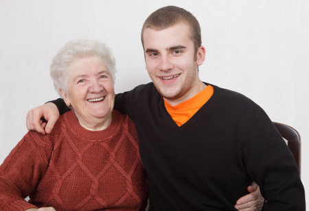 Senior  woman and grandson laughing and huggingの写真素材