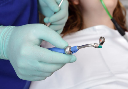 Close up dentist hand and tool for  filling of tooth