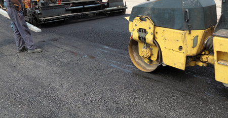 Road roller and asphalt paving machine at construction siteのeditorial素材