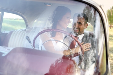 Bride and groom in a vintage carの写真素材