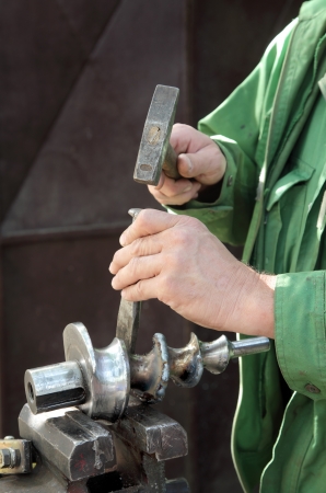 Welding slag removing with hammer and cutter after weldingの写真素材