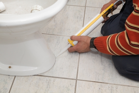 Plumber fixing bidet in a washroom with  silicone cartridgeの写真素材