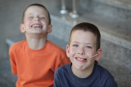 Two young boys with dirty face after ice cream eatingの写真素材