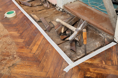 Old parquet floor remove with chisel, hammer toolsの写真素材