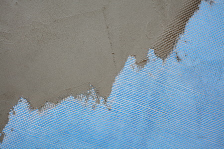 Closeup of layers over polystyrene insulation, mesh, plaster, cement, mortarの写真素材