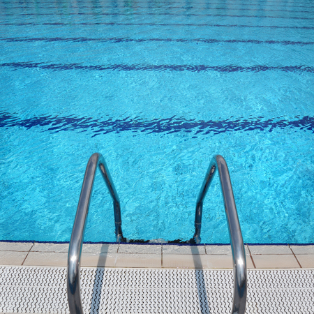 Open air swimming pool detail, steel ladder and clean turquoise water の写真素材
