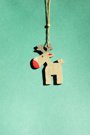Christmas reindeer. Wooden Christmas tree toy on a eucalyptus background.の写真素材