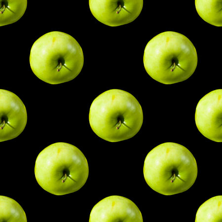 Seamless pattern from green apples on a black background. Photo collage.