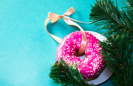 Sweet donut with a ribbon for Christmas tree decor. card. template for design.の写真素材