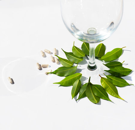 Round rosette of green leaves around a wine glass goblet. tablets. pills. capsules. alternative...
