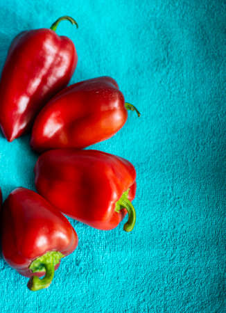 Bright ideas and designs. Red paprika is collected in a circle on a blue towel. Contrasting solutions. non-standard ideas. creativity.の写真素材