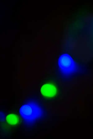Blue and green circles on a black background. round lights. Copy space for text.の写真素材