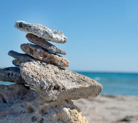 Pyramid of stones on the seashore. Beach. Relax. Horizon. Meditation. Thoughts about God and about yourself.の写真素材