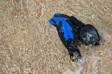 Fins for swimming and a mask for snorkeling on the beach. Wave and sand. Marine entertainment. Rest.の写真素材