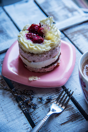 A small cake with white chocolate and raspberries.Delight for every celebration.の写真素材