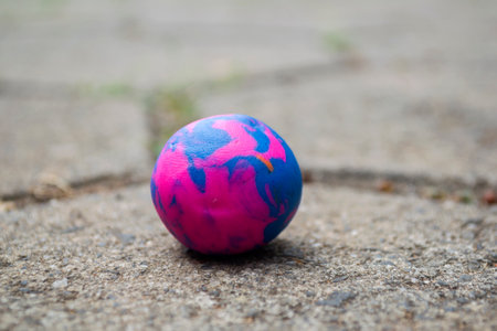 round wax toy like planet earth on cement floorの写真素材