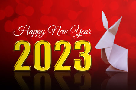 happy new year 2023  with origami rabbit on red backgroundの写真素材