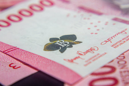 Close-up of Indonesian Rupiah banknotes showing security features and signatures.