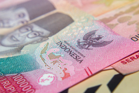Close-up of Indonesian Rupiah banknotes showing security features and signatures.