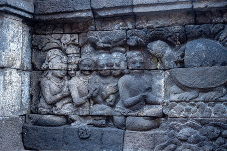 Ancient stone relief showing seated figures and animals in a storytelling scene.