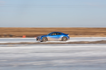 Moscow, Russia - March 1st, 2014: Moscow Subaru Forester club championship. This stage was located in Moscow, on the frozen pond track. The track was build by club members. Man driving his blue subaru BRZ on ice track, car sliding on the ice, snow. Panninのeditorial素材