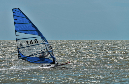 Dolzhanskaya spit, Russia - June 13, 2014: Strong wind in summer attracts many lovers of windsurfing and kitesurfing in the Dolzhanka, Krasnodar region, Russia.のeditorial素材