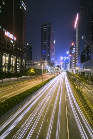 Hong Kong city lights at night  Light trails of passing cars and neon signs illuminate the never sleeping metropolis の写真素材