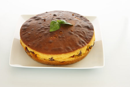 Fresh baked meat cake with ham, spicy sausage and olives.
