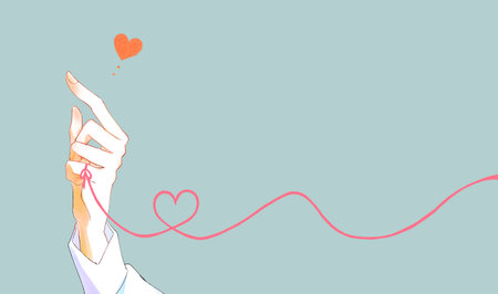 A man's hand tying the red thread of fateの写真素材