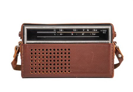 Image in close-up of an old transistor radio in a leather case isolated on white.の写真素材