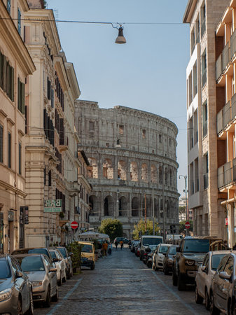 The colosseum peeking around the corner of a Roman street on a sunny summer day.の写真素材
