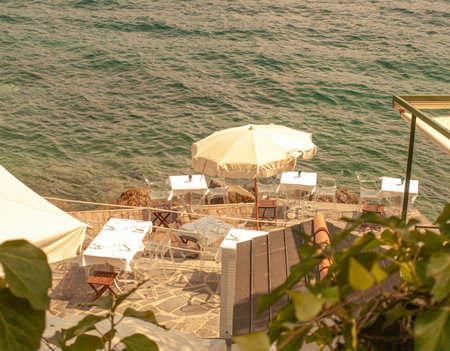 A beautiful cafe over looking the calm waters of the Liguria gulf.の写真素材