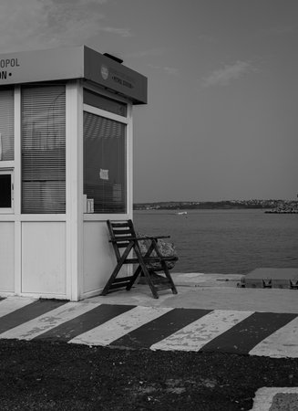 Black and white photo of a beach bar at the entrance to the seaの写真素材