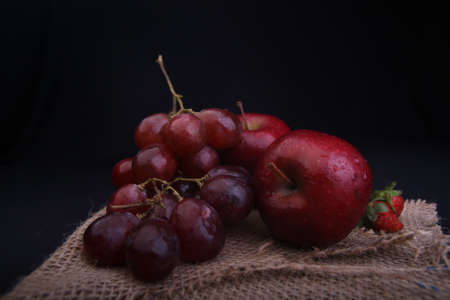 fresh red grape's and apple's with black backgroundの写真素材