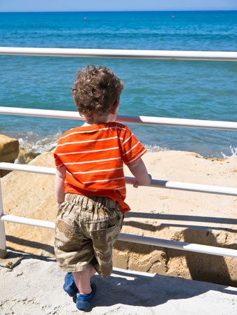 Young boy looking out to sea の写真素材