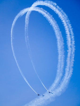 two aircraft complete a loop trailing smoke