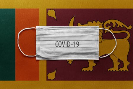 An individual face medical surgical mask on Sri Lanka National Flag Background. Health mask. Protection against COVID-19 virus, influenza, SARS. Save Sri Lanka from Coronavirusの写真素材