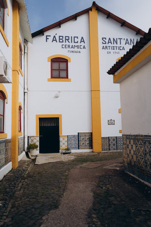 Lisbon house facade with white and yellow walls with azulejos ceramic tiles