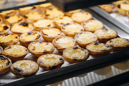 A tray with pasteis de nata, typical Portuguese egg tart pastries on a cafe showcase in Lisbon
