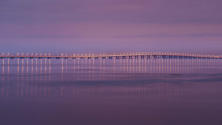 Vasco da Gama suspension bridge at in Lisbon, Portugal. Long exposure shoot. Dusk with red, pink...