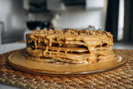 Sweet homemade honey cake with caramel and walnut nuts with kiwi and banana inside. Tasty brown cake...