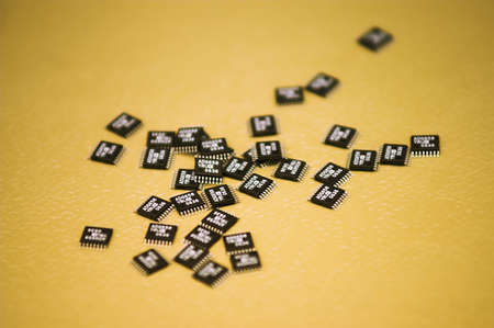 Microchips - A heap of microchips lying on a table.の写真素材