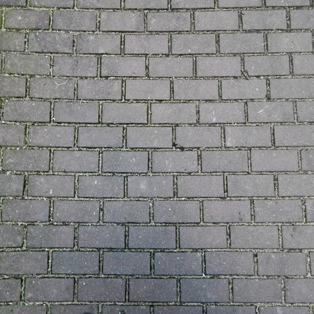 Textured background of a grey brick wallの写真素材
