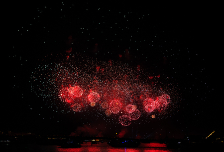 A red firework display in the night sky over river Neva at Scarlet Sails festivity in Saint Petersburg ,Russiaの写真素材