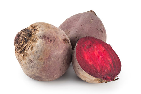 Two whole red beetroots and a half, isolated on white background