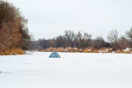 tents for winter fishing on the river.の写真素材