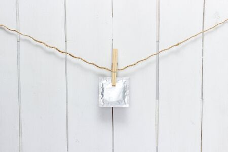 condoms weigh on a rope on the clothespinの写真素材