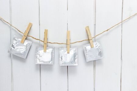 condoms weigh on a rope on the clothespinの写真素材
